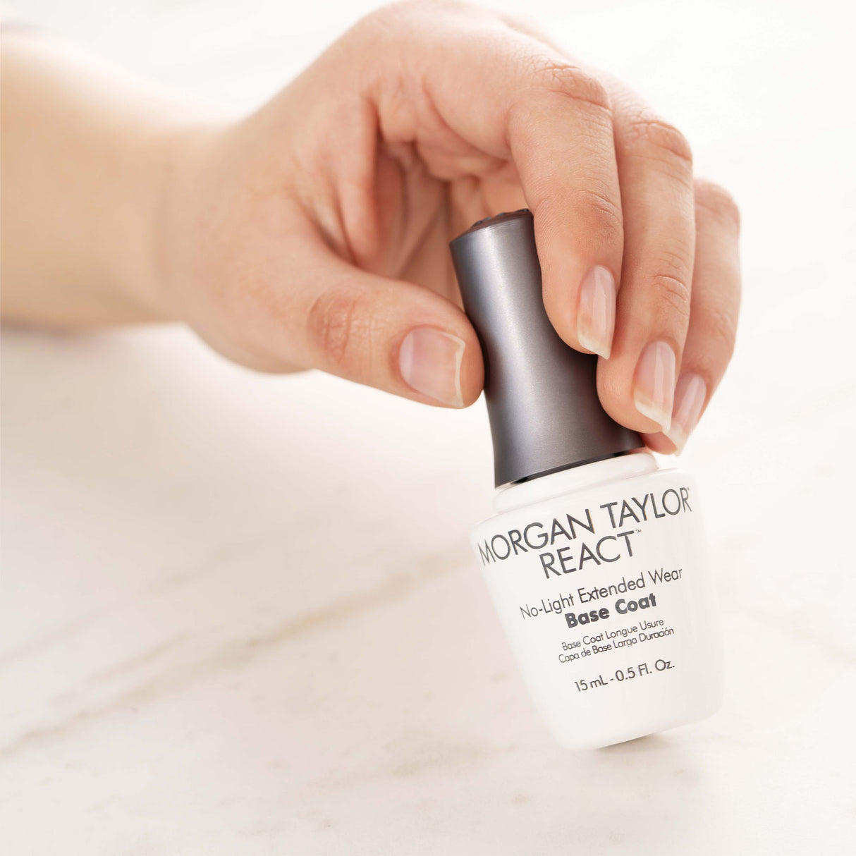 Morgan Taylor React Nail Polish Base Coat 15ml 0.5oz Bottle In Hand