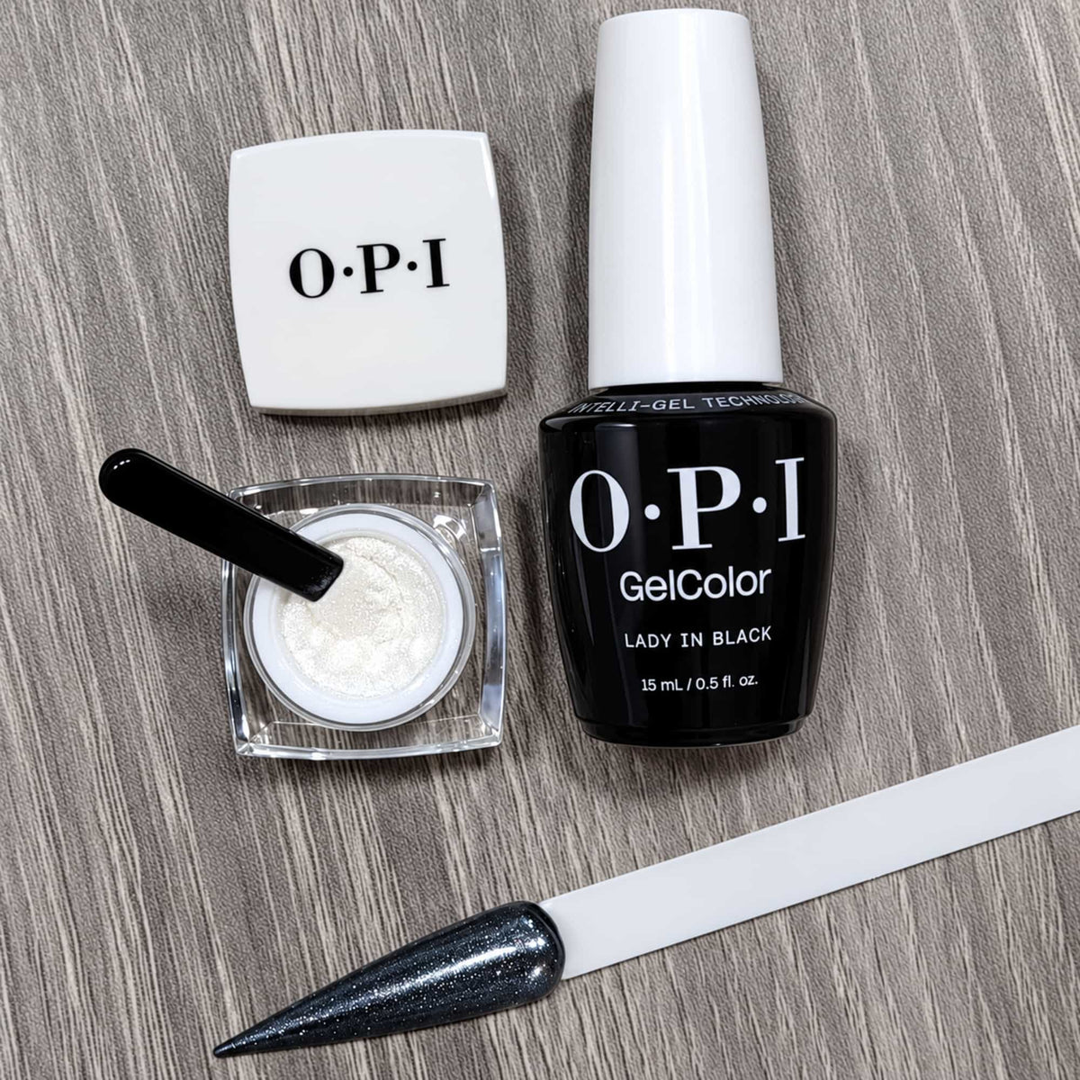 OPI Mirror Shine Chrome Powder - Tin Man Can Glaze Demo On Lady In Black Gel Polish With The Colour Stick Showing A Metallic Effect